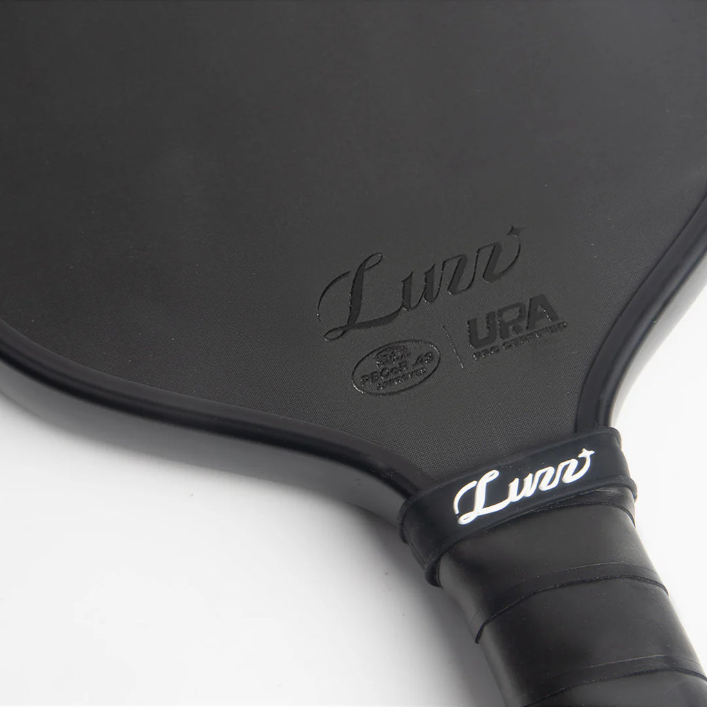 Close-up of a Luzz Pro Cannon black pickleball paddle with 'Luzz' branding, PBCoR .43 certification and UPA-A pro certification on a white background